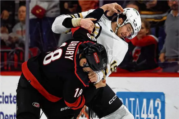  ?? KARL B DEBLAKER/ASSOCIATED PRESS ?? With his team trailing, 3-0, Jack Drury tried to get the Hurricanes jump-started by tangling with the Bruins’ Johnny Beecher.