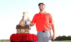  ??  ?? Rahm poses with the trophy after winning the Hero World Challenge at Albany, Bahamas. — AFP photo