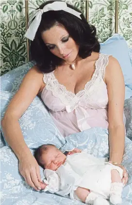  ??  ?? Baby love: A glamorous Joan Collins and third child, Katyana