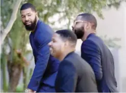  ??  ?? PHOENIX: NBA players Markieff, left, and Marcus Morris arrive with Gerald Bowman, right, at Superior Court for the second day of their aggravated assault trial, Tuesday in Phoenix. The twins and Bowman are charged with assaulting Erik Hood outside a...