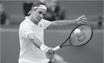  ?? ALASTAIR GRANT AP ?? Roger Federer plays a backhand return to Britain’s Cameron Norrie during a third-round match. Federer, 39, is the oldest man to reach the fourth round at Wimbledon since Ken Rosewall was 40 in 1975.