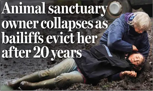  ??  ?? State of shock: A volunteer tends to Paula Campbell as she lies in the mud after being evicted from her home over mortgage arrears