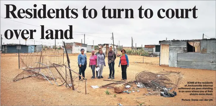  ??  ?? SOME of the residents of Jacksonvil­le informal settlement are seen standing in an area where one of their
shacks once stood. Picture: Danie van der Lith