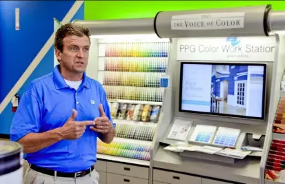  ?? Darrell Sapp/Post-Gazette ?? Tom Dougherty, director of marketing for PPG architectu­ral coatings, talks Tuesday in the newly opened PPG Paints store in Ross. In total, the company now owns 16 stores in the Pittsburgh area and 630 nationwide.