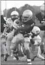  ?? Kevin Myrick / NPCo ?? Cedartown running back Kaelin Glover gets pulled down by Hiram defenders during the first quarter.