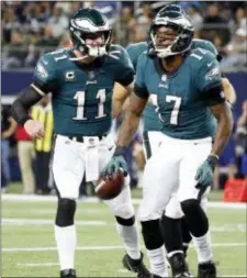  ?? THE ASSOCIATED PRESS FILE ?? The Eagles’ Alshon Jeffery, right in this celebratio­n shot with Carson Wentz against Dallas last season, said he didn’t know if he could be part of the starting lineup Sunday when the Eagles visit the Tennessee Titans.