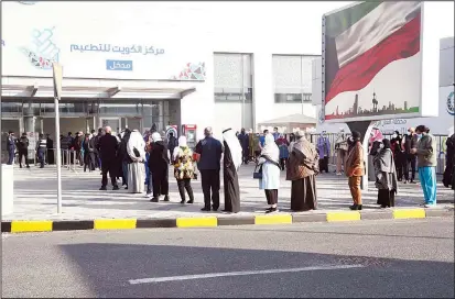  ?? Photo by Bassam Abu Shanab ?? People queue for the coronaviru­s vaccine as part of the national vaccinatio­n campaign at Kuwait Vaccinatio­n Center in Kuwait Fair Grounds, Mishref area.