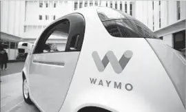  ?? Eric Risberg Associated Press ?? A WAYMO driverless car on display in San Francisco in December. Google’s selfdrivin­g car project is offering rides in Phoenix so that it can get feedback.