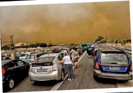  ??  ?? ABOVE: Greek firefighte­rs struggle to extinguish one of the many wildfires. LEFT: Traffic was gridlocked as the fire closed off one of Greece’s major highways near Athens. BELOW: Burnt-out cars on a road in the town of Mati. Drivers were forced to abandon their vehicles because of chaotic traffic jams .