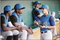  ?? Phelan M. Ebenhack / Associated Press ?? Tampa Tarpons manager Rachel Balkovec, right, chats in the dugout with pitchers Juan Carela, left, and Yon Castro, while making her debut as a minor league manager on Friday.