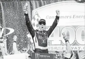  ?? PAUL SANCYA THE ASSOCIATED PRESS ?? Kevin Harvick celebrates after winning a NASCAR Cup Series auto race at Michigan Internatio­nal Speedway in Brooklyn, Mich., Sunday. It was the 47th win of his career.