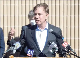  ?? H John Voorhees III / Hearst Connecticu­t Media ?? Governor Ned Lamont speaks after visiting a COVID-19 vaccinatio­n clinic for staff of local child care providers at Rogers Park School in Danbury on Friday.
