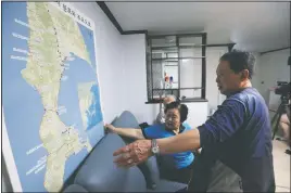  ??  ?? Shin and Lee Gwang-nam look at a map of Sakhalin.