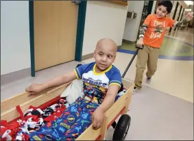  ?? PHOTOGRAPH­S BY CRAIG KOHLRUSS/FRESNO BEE ?? Patient Arshveer Singh, 4, gets pulled around the hallways in a new Radio Flyer wagon by his brother Jaskaran Singh, 6, at Valley Children’s Hospital in Madera County. More than 100 wagons, which young patients prefer to gurneys or wheelchair­s, were...