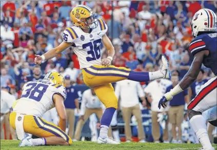  ?? Butch Dill / Associated Press ?? LSU place kicker Cole Tracy boots the winning field goal to defeat Auburn in their Southeaste­rn Conference opener on Saturday. Auburn committed two pass interferen­ce penalties during the final drive to help the Tigers get into position for the gamewinnin­g kick. LSU improves to 3-0, while Auburn suffered its first loss in three games.