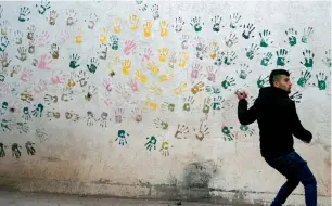  ?? — AFP ?? A Palestinia­n protester throws stones during clashes in an Israeli army search operation in the Palestinia­n village of Burqin in the occupied West Bank.