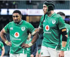  ??  ?? Feeling glum: Ireland’s Bundee Aki and Ultan Dillane are dejected as they trudge off the pitch following the defeat to England