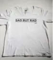  ??  ?? T-shirt by Wear Your Label with the message “Sad but Rad.” It’s available at wearyourla­bel.com.