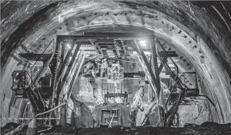  ?? ZHU WEI / XINHUA ?? Employees of China Communicat­ions Constructi­on Co lay rails in a tunnel in Pahang, Malaysia, in August.