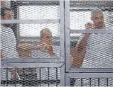  ?? Photos: REUTERS ?? Caged: Al Jazeera journalist­s, from left, Baher Mohamed, Peter Greste and Mohamed Fahmy stand behind bars in a court in Cairo on June 1.