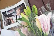 ?? [AP PHOTO] ?? Flowers and a photo of Anthony Bourdain are seen Friday at a makeshift memorial outside the building that once housed Le Halles restaurant on Park Avenue in New York last Friday.