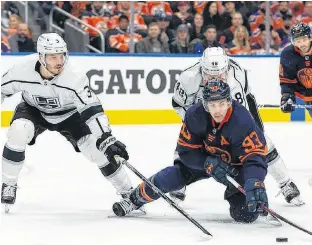  ?? POSTMEDIA NEWS ?? Edmonton Oilers’ Ryan Nugent-hopkins (93) battles L.A. Kings’ Brendan Lemieux (48) and Matt Roy (3) during first period NHL action in Game 2 of their first round Stanley Cup playoff series in Edmonton, on May 4.