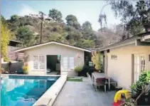  ?? Assembledg­e+ ?? THE TEPPER house’s backyard and pool before the renovation.