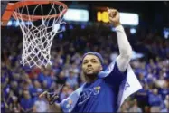  ?? ORLIN WAGNER — THE ASSOCIATED PRESS ?? Kansas guard Frank Mason III (0) cuts down the net following an NCAA basketball game against Texas Tech in Lawrence, Kan., Saturday. Kansas defeated Texas Tech 67-58. Kansas clinched a tie for their 12th Big 12title in a row.