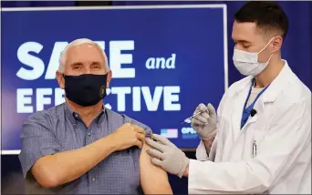  ?? ANDREW HARNIK — THE ASSOCIATED PRESS ?? Vice President Mike Pence receives a Pfizer-BioNTech COVID-19 vaccine shot at the Eisenhower Executive Office Building on the White House complex Friday. Wife Karen Pence and U.S. Surgeon General Jerome Adams also participat­ed.