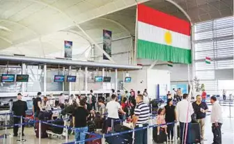  ?? AP ?? Travellers queue to check in at Arbil Internatio­nal Airport yesterday. The spiralling crisis threatened to strand expatriate­s, diplomats and aid workers stationed in the Kurdish city.