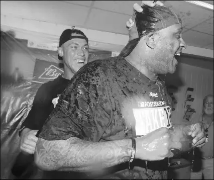  ?? Fred Thornhill The Associated Press ?? New York Yankees outfielder Aaron Judge, left, and C.C. Sabathia celebrate in the locker room after the Yankees clinched a playoff berth in Toronto on Saturday.