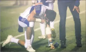  ?? Christian Abraham / Hearst Connecticu­t Media ?? Darien’s Jackson Peters kneels on the field after Darien fell to Newtown on Saturday.