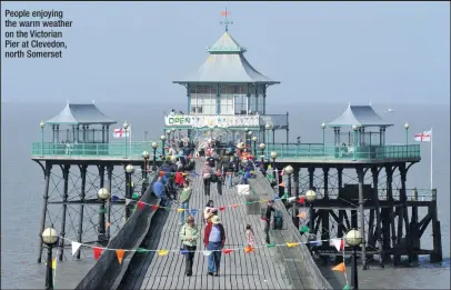  ??  ?? People enjoying the warm weather on the Victorian Pier at Clevedon, north Somerset