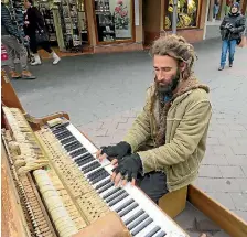  ??  ?? Queenstown busker AJ Hickling plays classical music on a piano he salvaged from a dump.