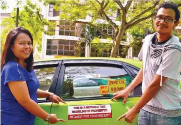  ??  ?? Fare deal: Shafiu (right) and Taximonger co-founder and business developmen­t executive Nizreen Noordin posing in front of a taxi in Petaling Jaya.