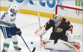  ?? The Associated Press ?? Anaheim Ducks goaltender John Gibson stops a shot from Vancouver Canucks forward Brandon Sutter during second-period NHL action in Anaheim, Calif., on Wednesday night.