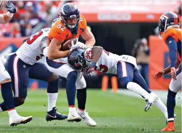  ?? Jack Dempsey/Associated Press ?? ■ Denver Broncos tight end Jeff Heuerman (82) is hit by Houston Texans strong safety Kareem Jackson (25) Sunday during the first half of an NFL game in Denver.