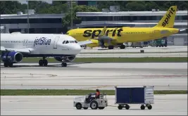  ?? WILFREDO LEE — THE ASSOCIATED PRESS ?? A JetBlue Airways Airbus A320passes a Spirit Airlines Airbus A320at the Fort Lauderdale-Hollywood Internatio­nal Airport in Florida. A federal judge blocked the companies' proposed merger in January, siding with the Justice Department.