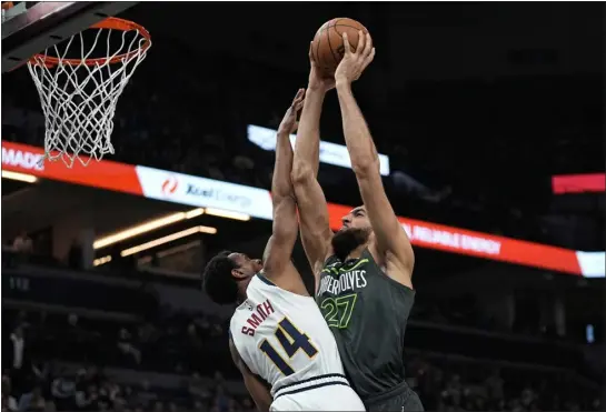  ?? ABBIE PARR — THE ASSOCIATED PRESS ?? Timberwolv­es center Rudy Gobert, center, goes up for a shot against Nuggets guard Ish Smith on Sunday in Minneapoli­s.
