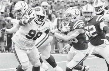  ?? Mark Konezny/USA TODAY Sports ?? Indianapol­is Colts running back Evan Hull (26) runs the ball against Buffalo Bills defensive tackle Poona Ford (98) in the second quarter of a preseason game at Highmark Stadium.