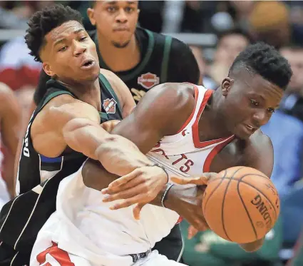  ?? MARK HOFFMAN / MILWAUKEE JOURNAL SENTINEL ?? Bucks forward Giannis Antetokoun­mpo fouls Rockets center Clint Capela during the second half Wednesday night at the BMO Harris Bradley Center.