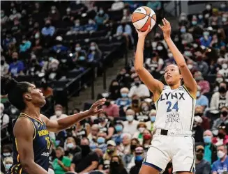  ?? David Joles/Associated Press ?? Minnesota Lynx forward Napheesa Collier shoots over Indiana Fever center Teaira McCowan during a 2021 WNBA game in Minneapoli­s.