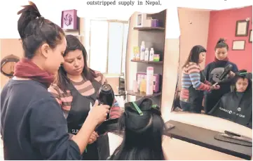  ??  ?? In this photograph taken on Jan 26,‘Blush Beauty Point’ parlour owner Anita Shrestha (centre) attends to a customer’s hair in Kathmandu. The continuous whirl of hair dryers is a novel sound at the Blush Beauty Point parlour in Nepal’s capital...