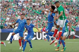  ?? AP ?? Mexico’s Hedgardo Marin (right) heads the ball to score a goal against El Salvador during a CONCACAF Gold Cup match in San Diego on Sunday. —