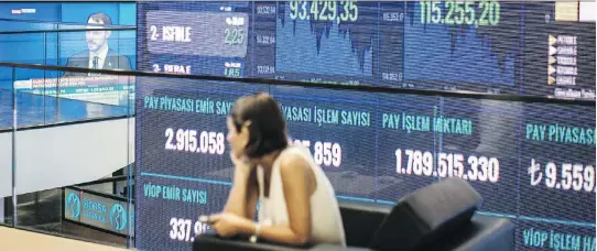  ?? ISMAIL FERDOUS/BLOOMBERG ?? A digital screen broadcasts a speech by Turkey’s Finance Minister Berat Albayrak at the Borsa Istanbul stock exchange on Tuesday. The Turkish policy response to its faltering currency seemed to be to do nothing to solve a crisis of its own making, writes Joe Chidley.