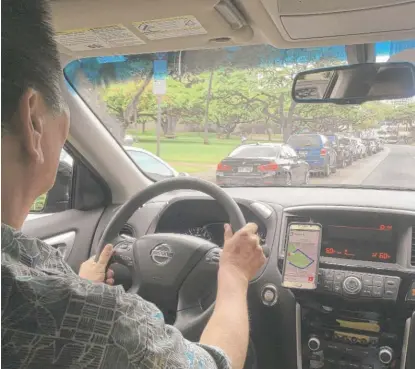  ?? JENNIFER SINCO KELLEHER/ AP ?? Uber driver Joshua Oh drives in Honolulu on Wednesday. Uber sent emails to customers across the island of Oahu urging them to oppose Honolulu rules that would impose “outdated taxi- style requiremen­ts on rideshare.”