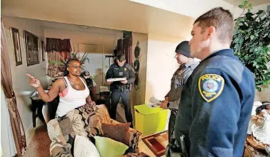  ?? [PHOTOS BY STEVE GOOCH, THE OKLAHOMAN] ?? Maria Graves talks with Oklahoma City police officers Eric Gengnagel, left, Joshua Gershon and Billy Robison at her home in northeast Oklahoma City.