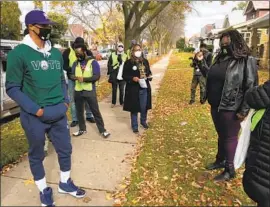  ?? DEMOCRATS Steve Megargee Associated Press ?? had asked the court to allow mail- in ballots received after election day. Above, Milwaukee Bucks guard George Hill canvasses voters on Oct. 24.