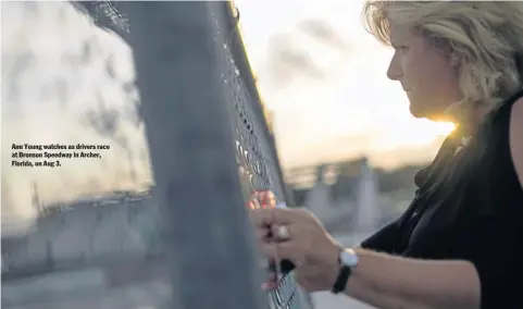  ??  ?? Ann Young watches as drivers race at Bronson Speedway in Archer, Florida, on Aug 3.
NYT