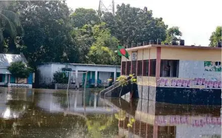  ?? IPS PIC ?? A school inundated by floodwater­s in Manikganj, Bangladesh. It took scientists two decades to conclude that climate change is caused by human activities.